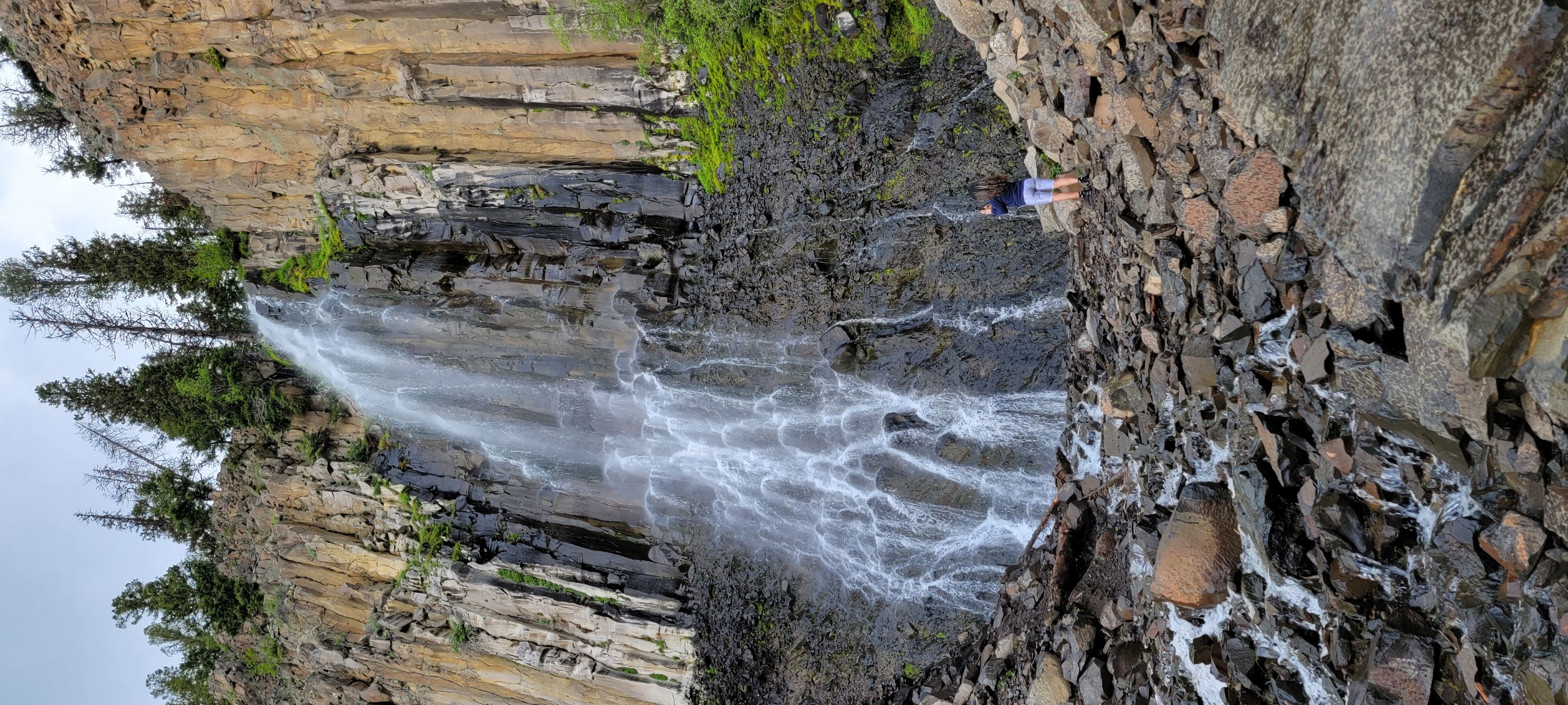 4'11" Woman at Palisade Falls to show how tall is this Montana waterfall.